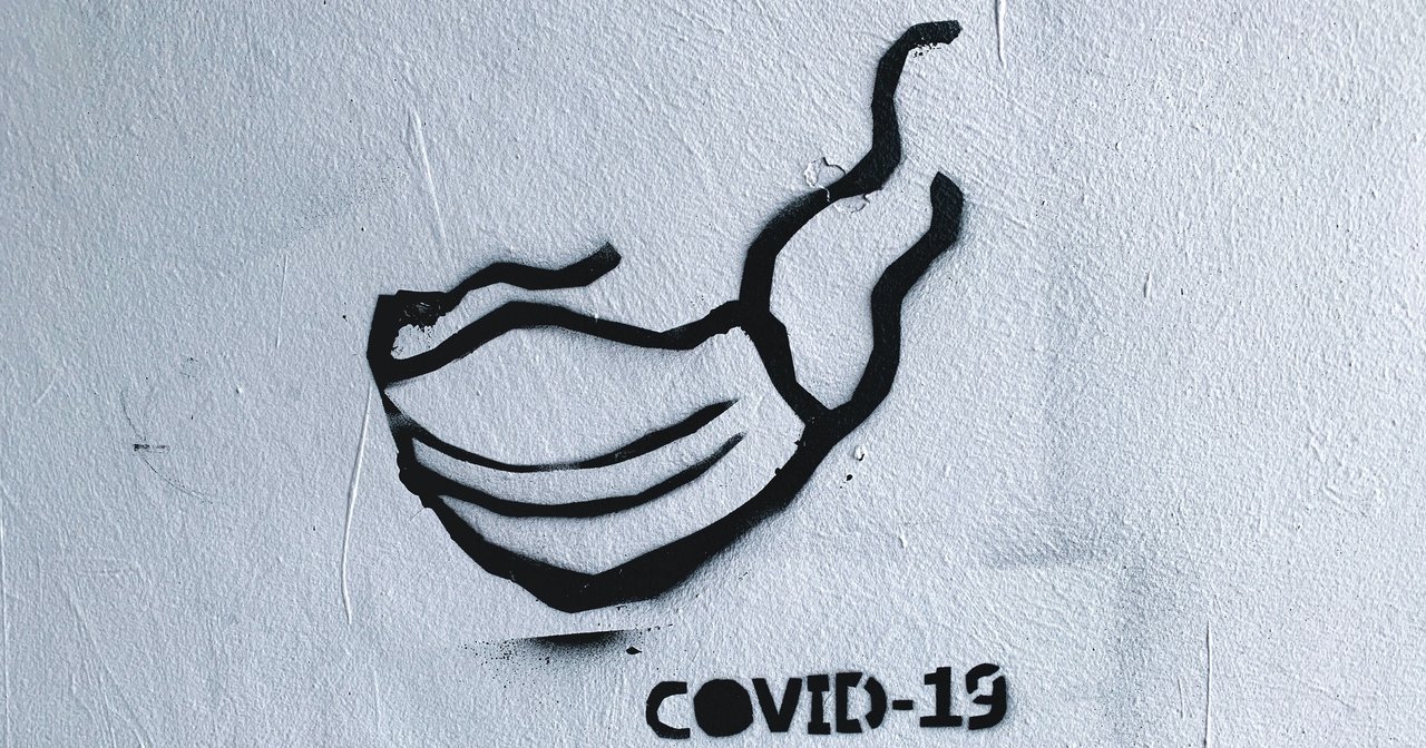 Graffiti of mask and word "COVID-19"