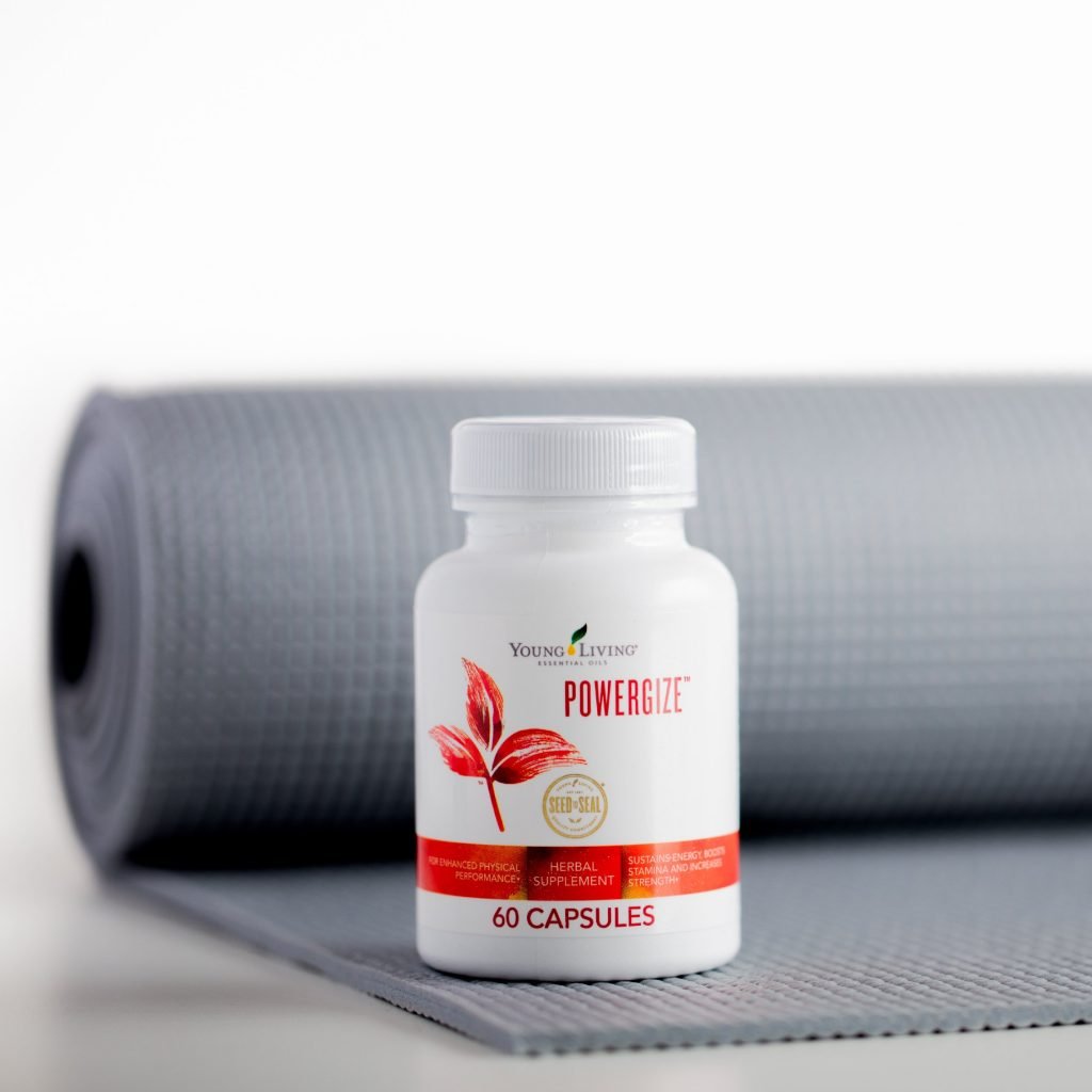 Bottle of Young Living PowerGize on gray exercise mat