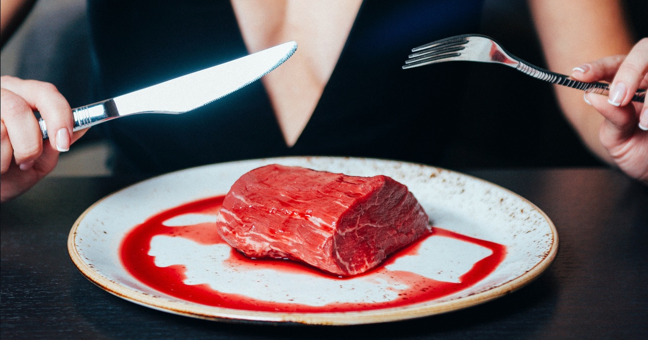 Woman about to eat raw steak