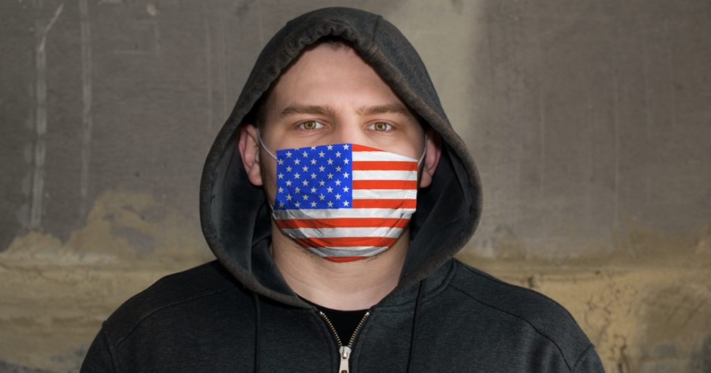 Man wearing mask with U.S. flag on it