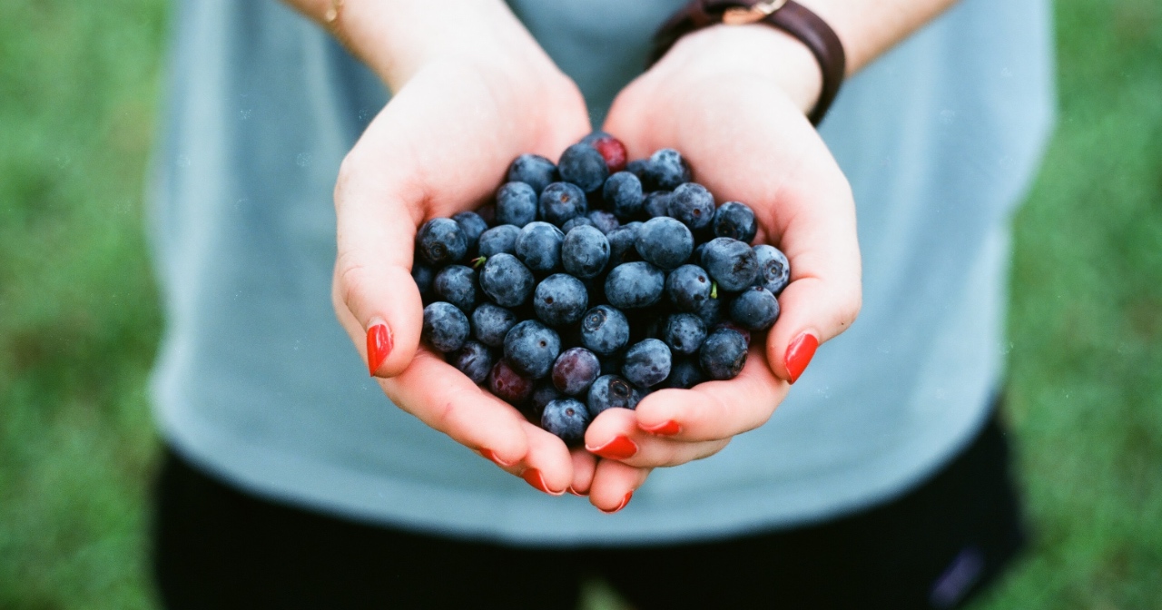 Woman holding a handful of blueberries