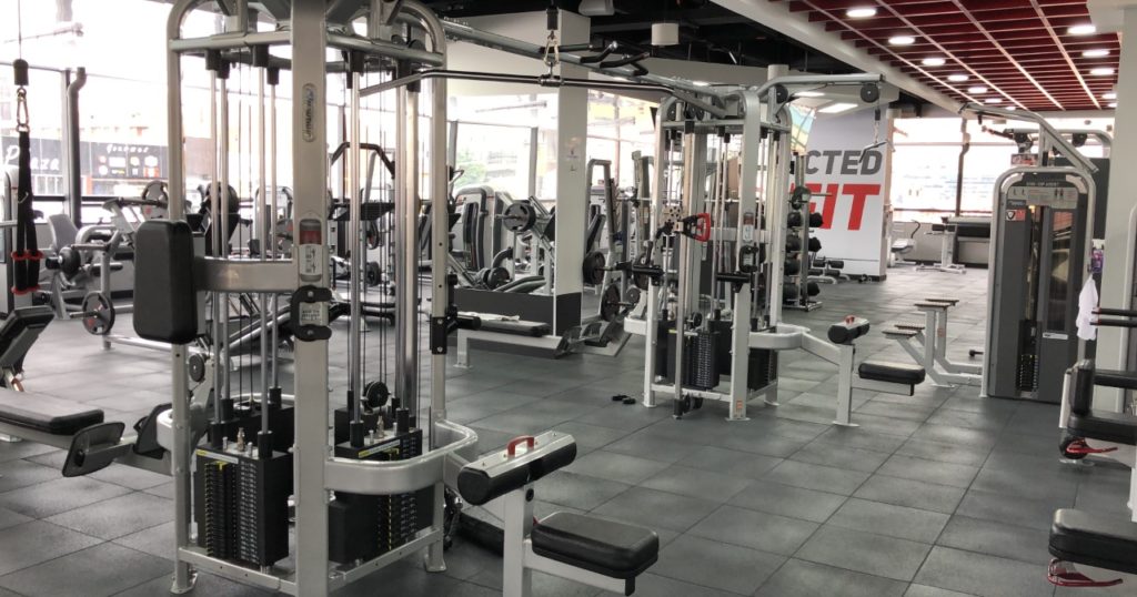 Commercial gym full of machines and free weights