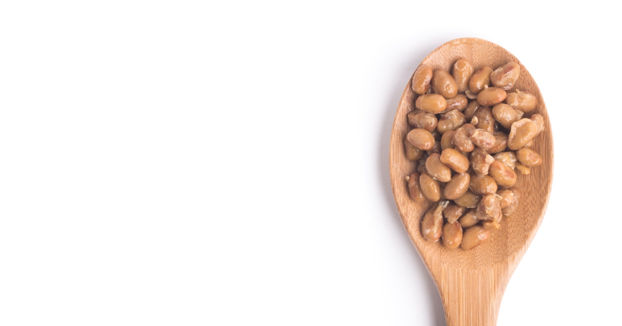 Natto on wooden spoon with white background