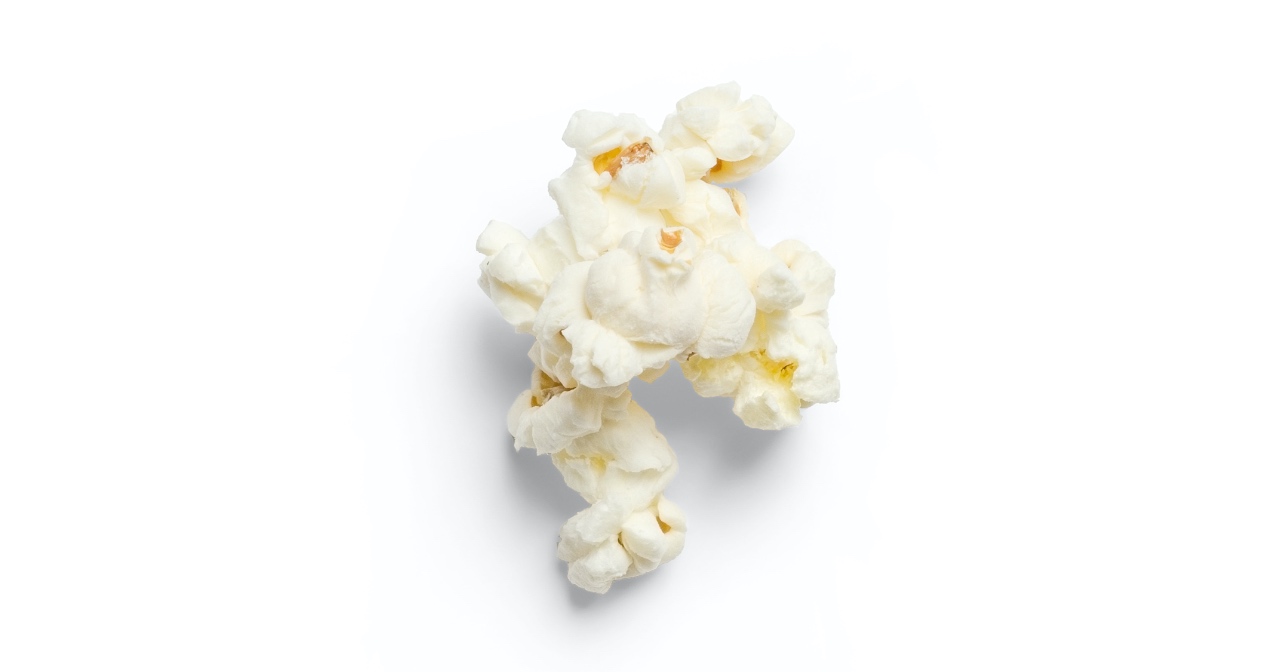 Piece of popcorn on white background