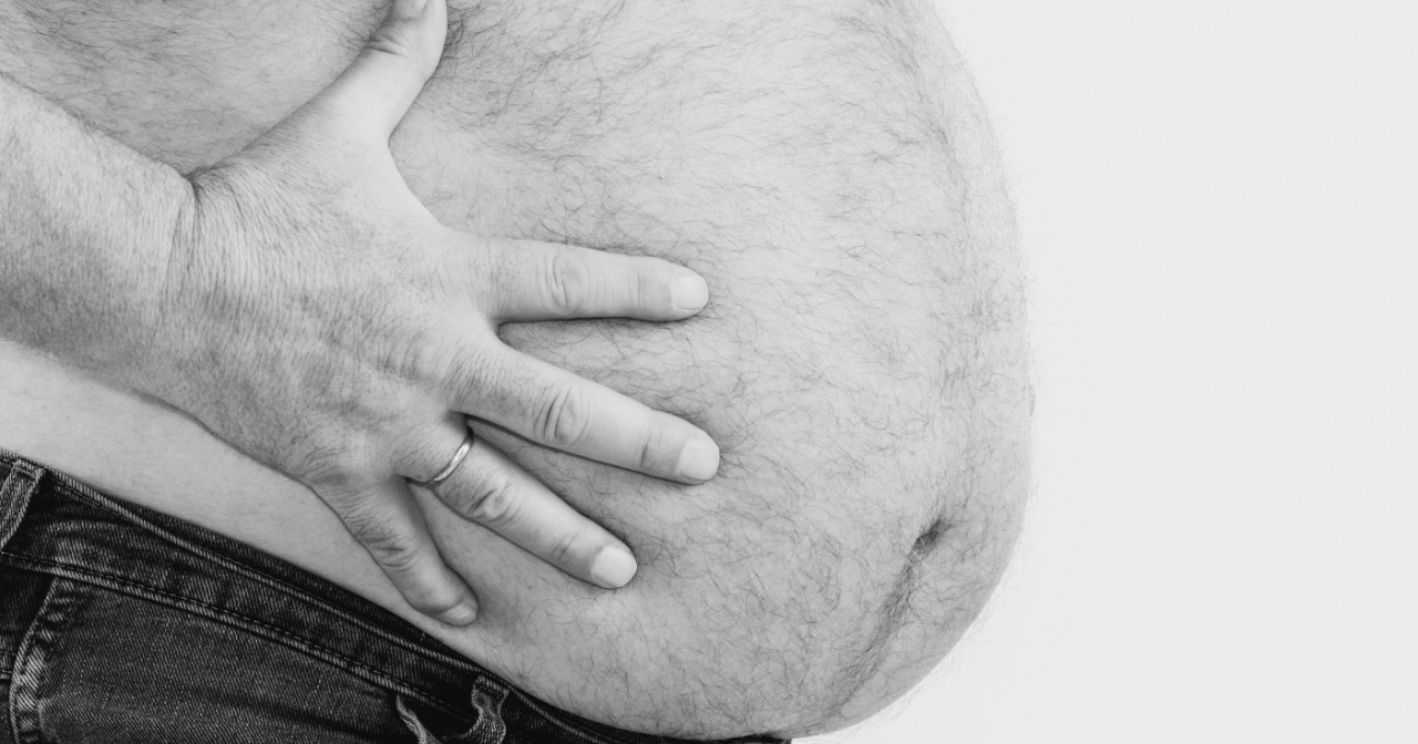 Man holding his overweight belly