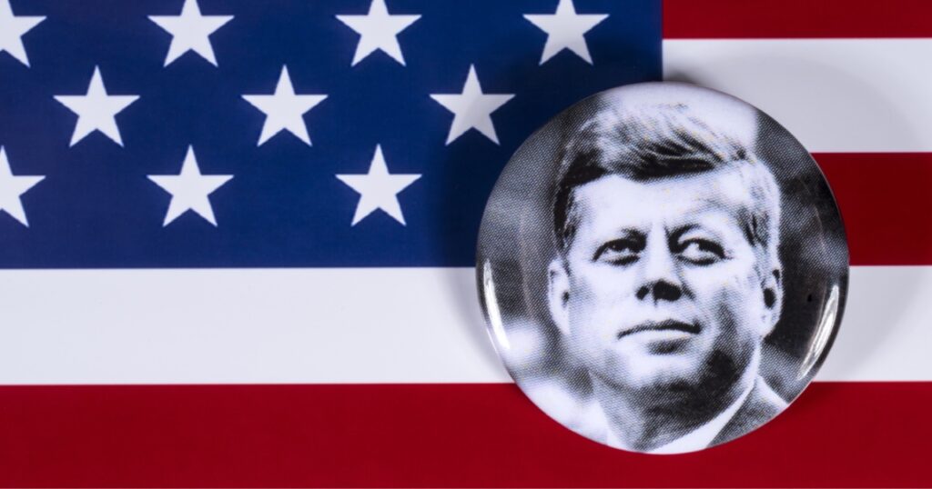 JFK button over American flag