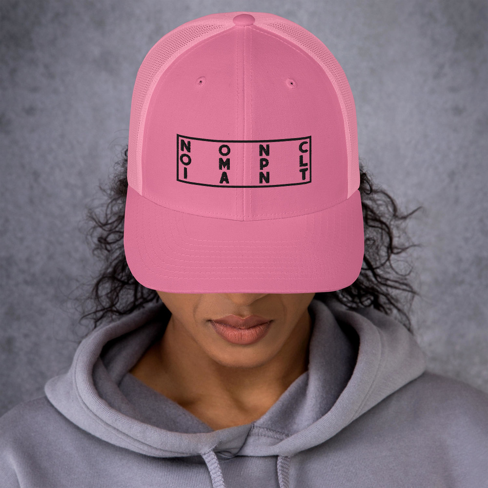 Woman wearing pink NONCOMPLIANT hat