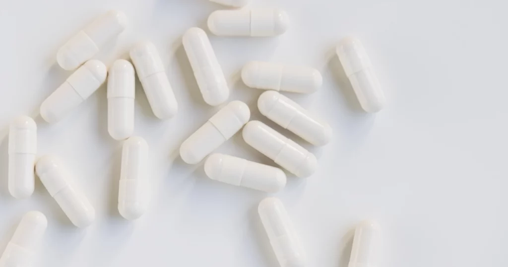 white capsules on white background