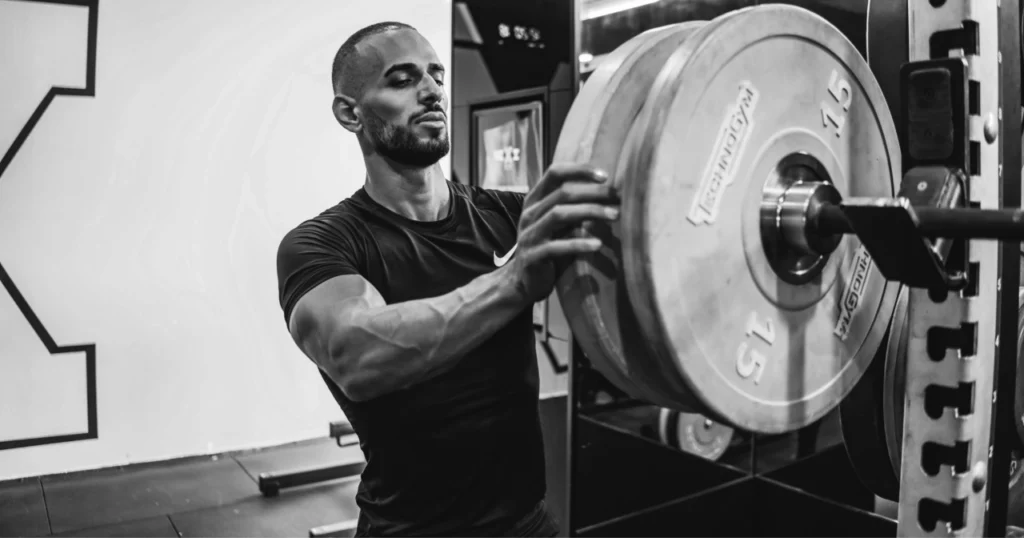 Man loading plates to barbell