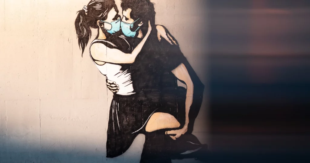 Art of couple kissing with masks on