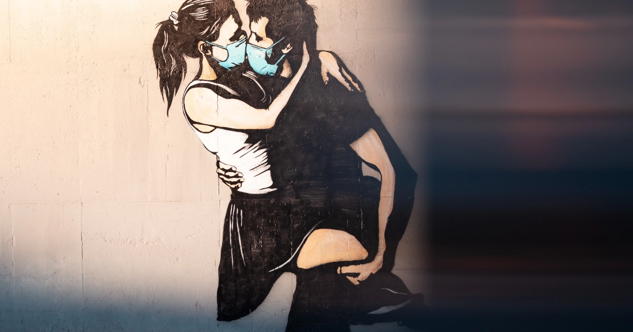Art of couple kissing with masks on