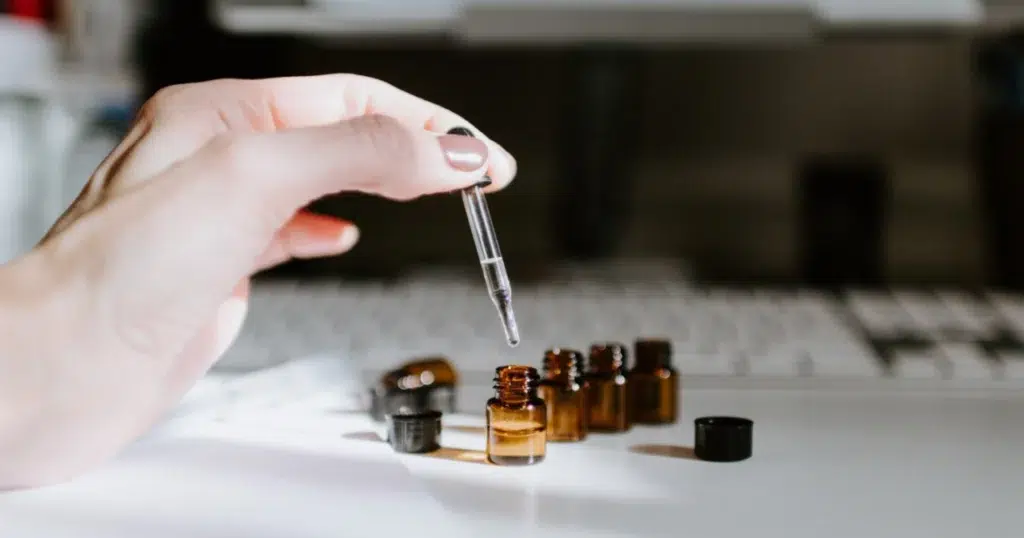 Dropping essential oils into bottles