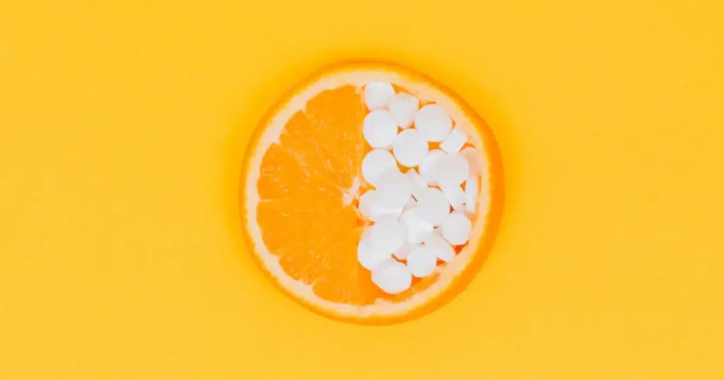 Orange slice half-filled with supplements