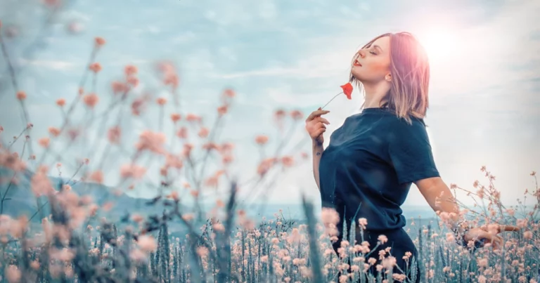 Woman holding flower in field