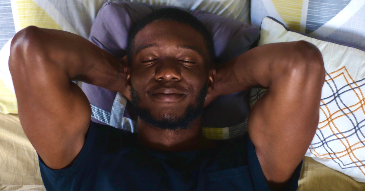 Man sleeping with slight smile on his face exemplifying melatonin for sleep